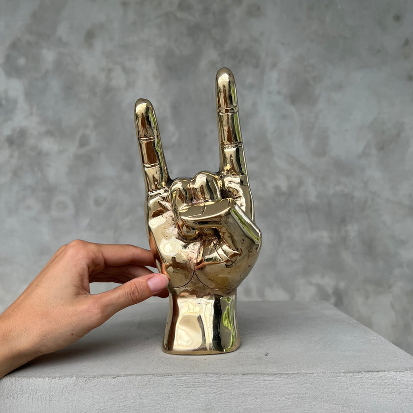 Hand Rock On Polished Brass