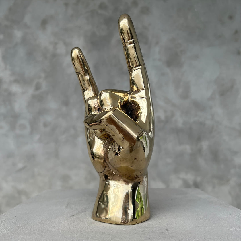 Hand Rock On Polished Brass
