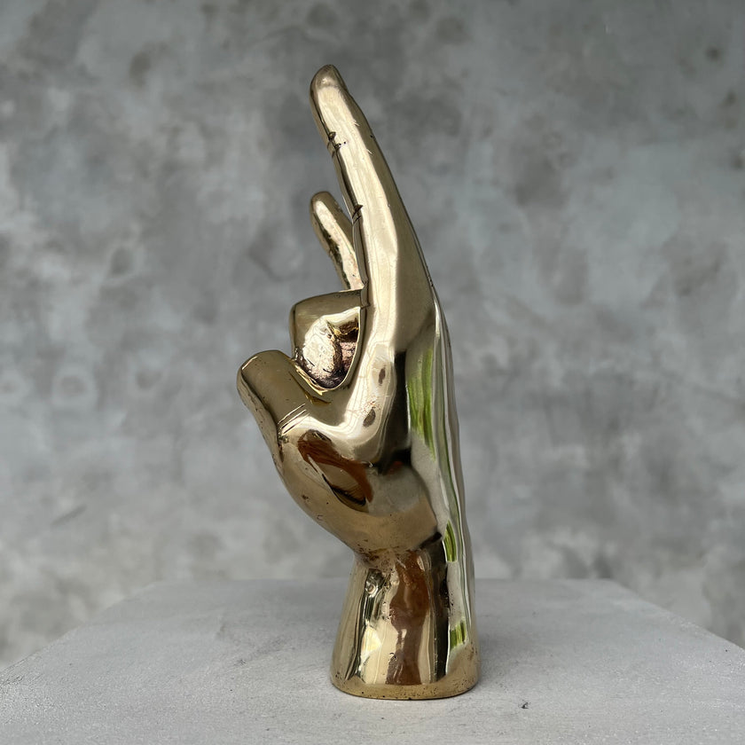 Hand Rock On Polished Brass