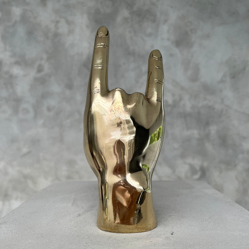 Hand Rock On Polished Brass