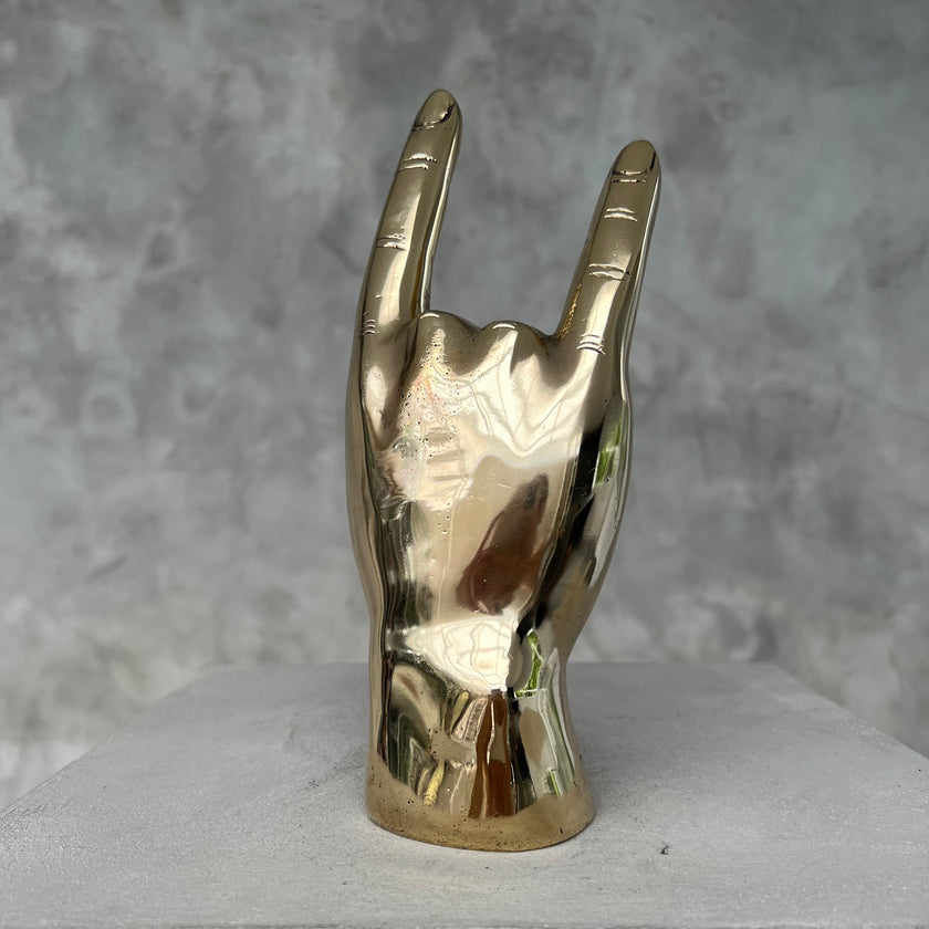 Hand Rock On Polished Brass