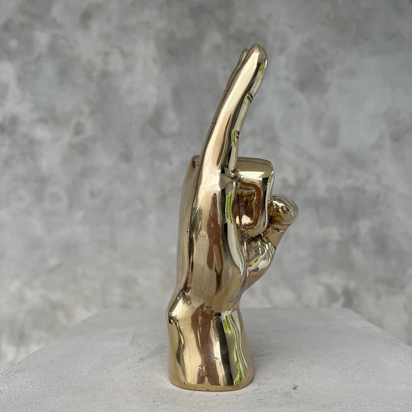 Hand Rock On Polished Brass