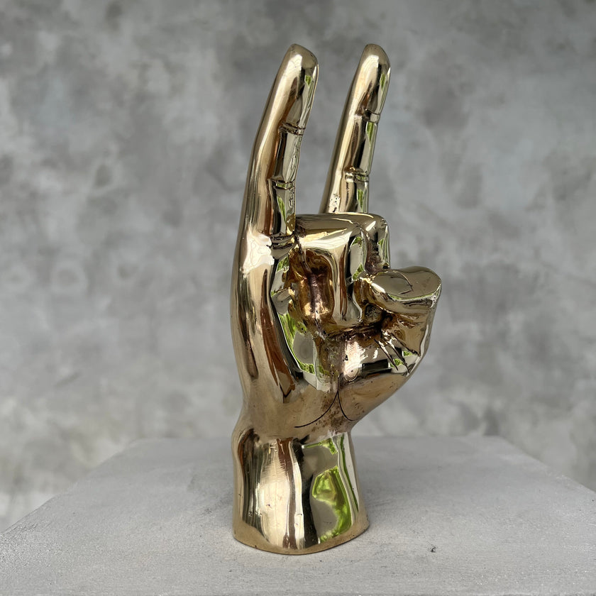 Hand Rock On Polished Brass